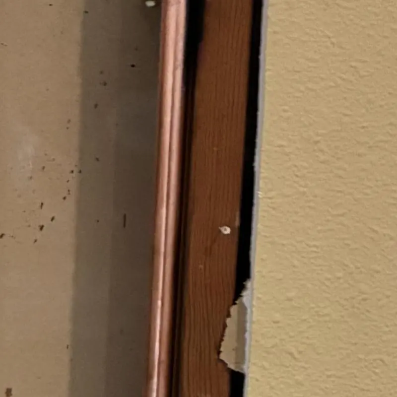 Three-quarter inch copper hot water line behind drywall