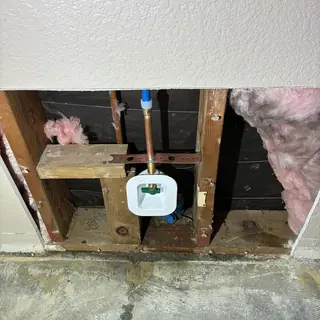 Ice maker water line reroute inside wall cavity