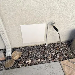 Roman tub valve access panel cut in exterior wall